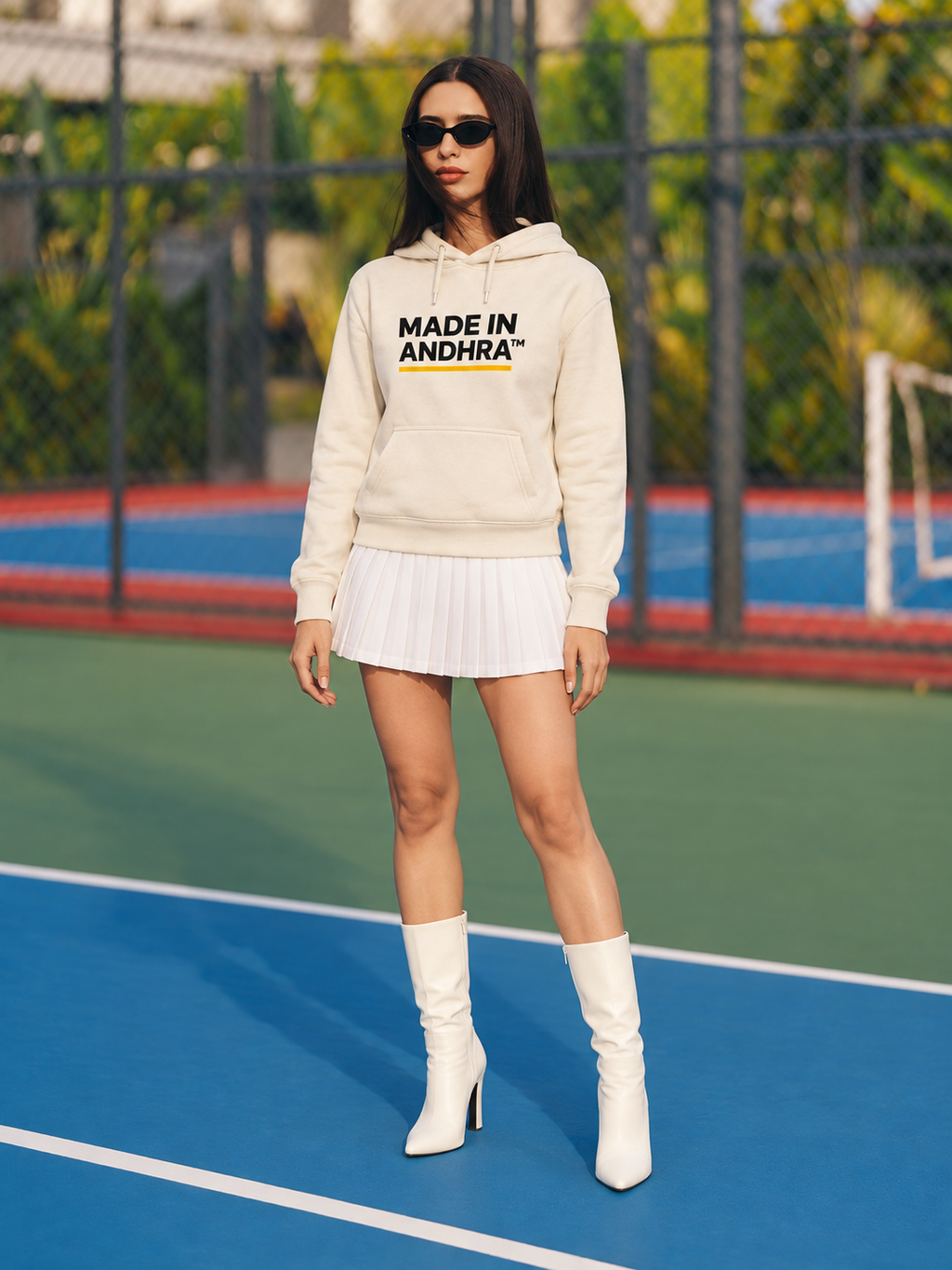 Made in Andhra™ Women's Cream Airport Hoodie — full-length front view on a tennis court