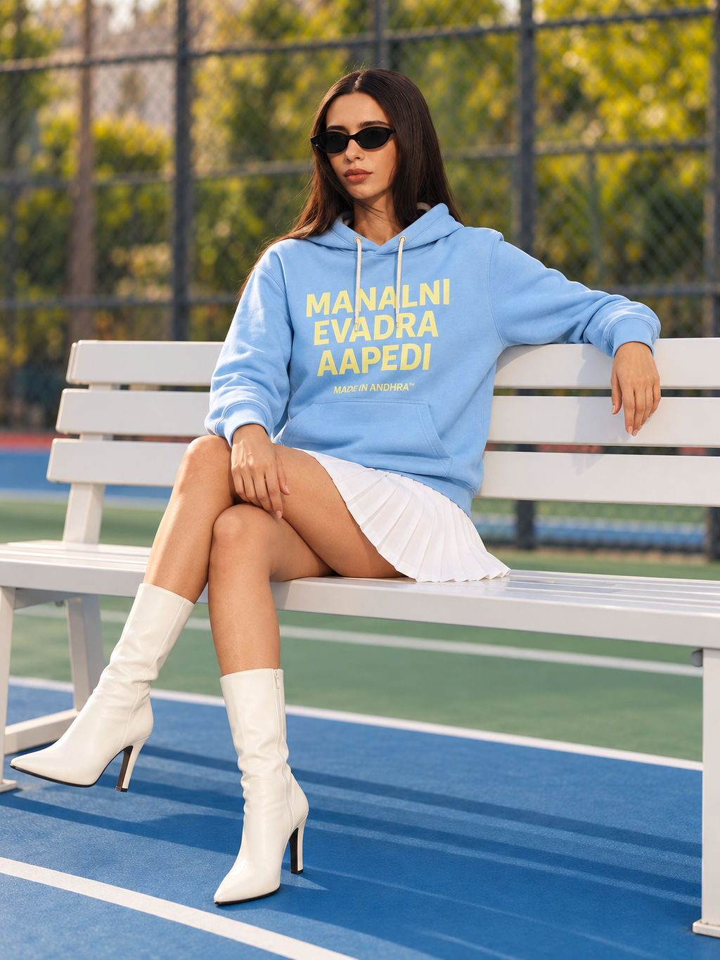 Made in Andhra™ Manalni Evadra Aapedi Hoodie — women seated lifestyle